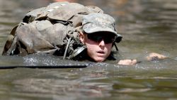 A female Army Ranger student crosses the Yellow River on a rope bridge on Tuesday, Aug. 4, 2015, at Camp James E. Rudder on Eglin Air Force Base, Fla. Two out of 19 females have made it to the final phase of Army Ranger training which ends at Camp James E. Rudder on Eglin Air Force Base. Pentagon leaders decided in 2013 to investigate the possibility  of opening all military jobs to women. (Nick Tomecek/Northwest Florida Daily News via AP)