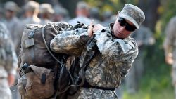 A female Army Ranger student lifts a rucksack onto her back on Tuesday, Aug. 4, 2015, at Camp James E. Rudder on Eglin Air Force Base, Fla. Two out of 19 females have made it to the final phase of Army Ranger training which ends at Camp James E. Rudder on Eglin Air Force Base. (Nick Tomecek/Northwest Florida Daily News via AP)