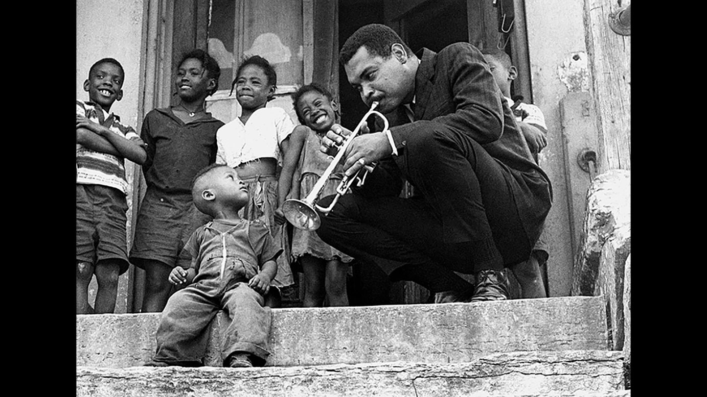 Trumpeter Art Farmer plays for a group of admiring children in this 1961 shot. In addition to the trumpet, Farmer was expert at playing the flugelhorn. He often played along with his twin brother, bassist Addison Farmer.