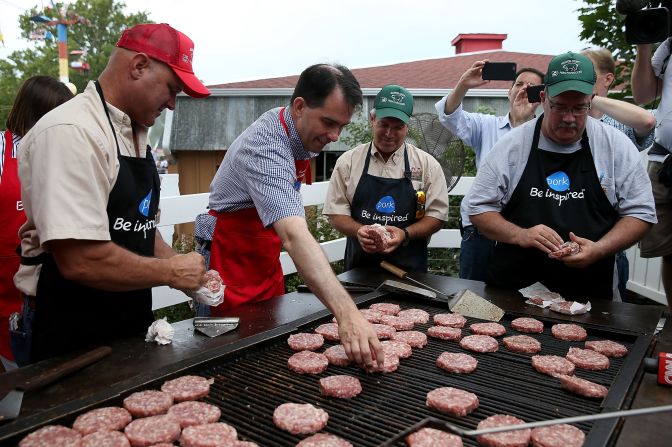 Wisconsin Gov. Scott Walker, a Republican presidential candidate, wears a red apron as he works the grill at the Iowa Pork Producers tent on August 17.