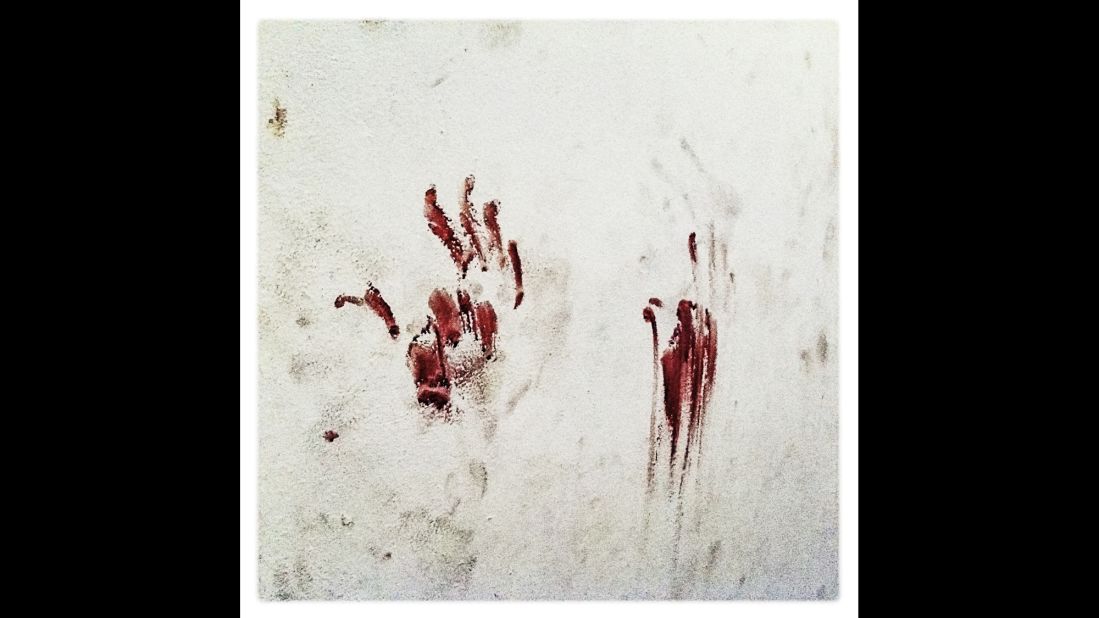 Bloody handprints stain a former secret police cell inside an elementary school in Tripoli, Libya, in August 2011.