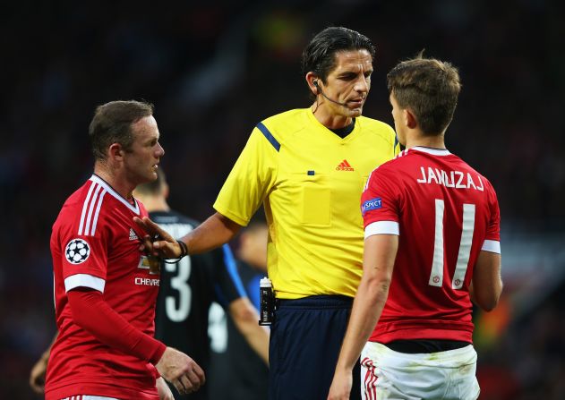 Referee Deniz Aytekin shows Adnan Januzaj and Wayne Rooney who's boss.