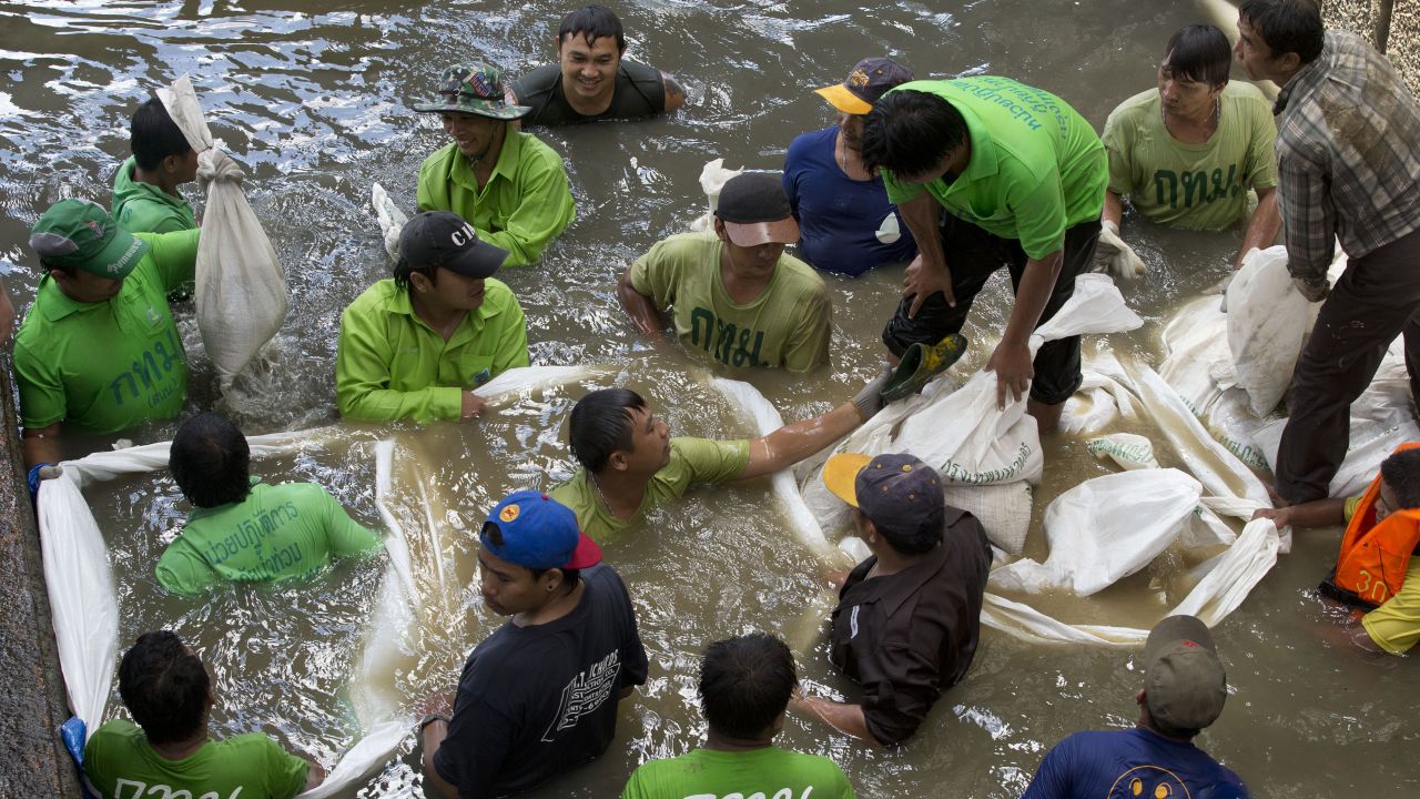 Workers build a dam from sandbags on August 19 as they attempt to seal off a canal to search for remnants of an explosive device that was thrown into the canal in Bangkok on Tuesday. Police spokesman Lt. Gen. Prawut Thavornsiri said Tuesday's blast at the Sathorn Pier was caused by a pipe bomb and could be related to the deadly explosion at a popular shrine in central Bangkok on Monday.