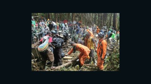 Indonesian rescue workers recover bodies at the crash site.