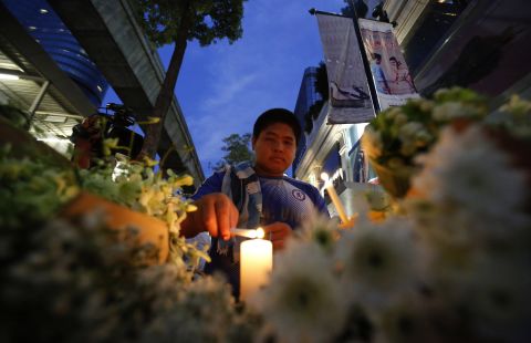 A Thai lights a candle near the Erawan Shrine  the day after the explosion in Bangkok. 