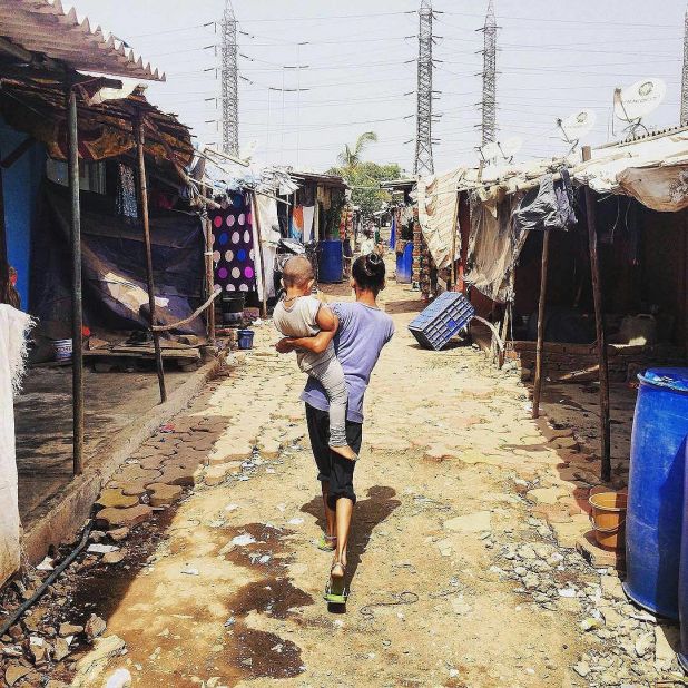 "We had to do an enormous amount of on the ground research to ensure that our features are aligned with the human experience of living in informal settlements," said Gluckman. Pictured, a mother and child in Wadala settlement, Mumbai. 