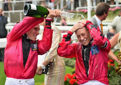 Captain of the Girls Team Emma-Jayne Wilson showers Bell with champagne after the apprentice helped seal the first-ever win for a female team in the annual competition.