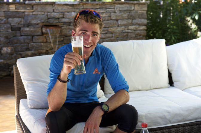 Mountains navigated, the 26-year-old enjoys a relaxing beer after reaching base.