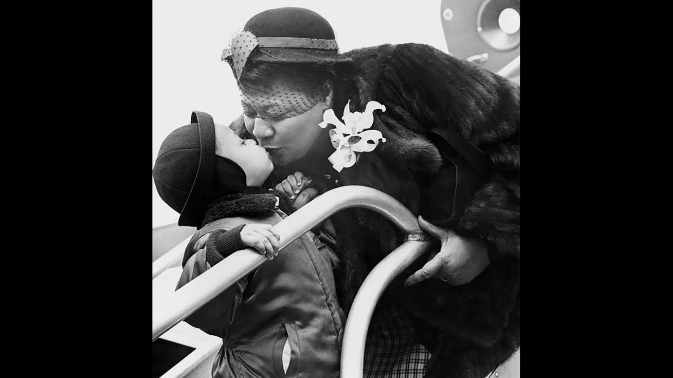 Legendary jazz singer Ella Fitzgerald has been dubbed the "First Lady of Song," and she was beloved worldwide for her delicate phrasing and dazzling ability to imitate instruments and scat-sing. This photo from the August 1952 issue of Metronome was captioned "Ella Fitzgerald greets an admiring Junior upon her return from Europe."