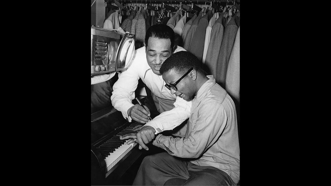 Composer and bandleader Duke Ellington hovers over fellow pianist and band member Billy Strayhorn in this 1948 photograph. Ellington's catalog of more than 3,000 songs made him one of the most prolific and admired figures in American music. His best-known tunes include "It Don't Mean a Thing if It Ain't Got That Swing," "Sophisticated Lady" and "Mood Indigo." Strayhorn is known for his songs "Take the A Train," "Lush Life" and "Chelsea Bridge."