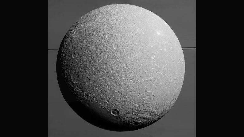 Saturn's icy moon Dione, with giant Saturn and its rings in the background, was captured in this mosaic of images just prior the <a href="index.php?page=&url=http%3A%2F%2Fsaturn.jpl.nasa.gov%2F" target="_blank" target="_blank">Cassini spacecraft's</a> final close approach to the moon on August 17, 2015. Scientists combined nine visible light images to create the mosaic. Cassini was at distances ranging from approximately 106,000 miles (170,000 kilometers) to 39,000 miles (63,000 kilometers) from Dione when the images were taken.