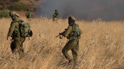 Israeli soldiers inspect a field where rockets fired from Syria landed near Kfar Szold, causing fires but no injuries, in northern Israel, close to the Golan Heights and the border with Lebanon, on August 20, 2015. Israel launched artillery and air strikes against Syrian army positions in the Golan Heights overnight in response to rocket fire that hit the Upper Galilee and the Israeli-annexed side of the Golan Heights, according to Israeli military sources.