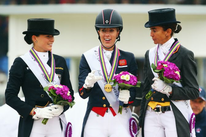 Dressage star Charlotte Dujardin (center) poses with second placed Kristina Broering-Sprehe (left) of Germany and third placed Beatriz Ferrer-Salat of Spain after winning the Dressage Grand Prix Freestyle individual competition. The current Olympic and World champion, Dujardin helped Britain to a haul of two golds and one silver medal at the championships.