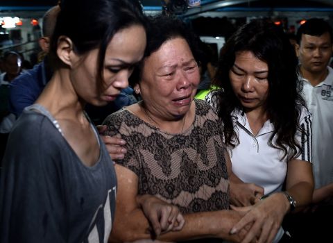 Family members of Neoh Hock Guan ,a Malaysian survivor of the Bangkok bomb blast, break down as they pay their last respects. Five out of the seven Neoh family members traveling to Bangkok together were killed in the blast. 