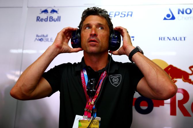 Dempsey is pictured watching the action from inside the Scuderia Toro Rosso garage during qualifying ahead of the German Grand Prix at Hockenheimring in July 2014.