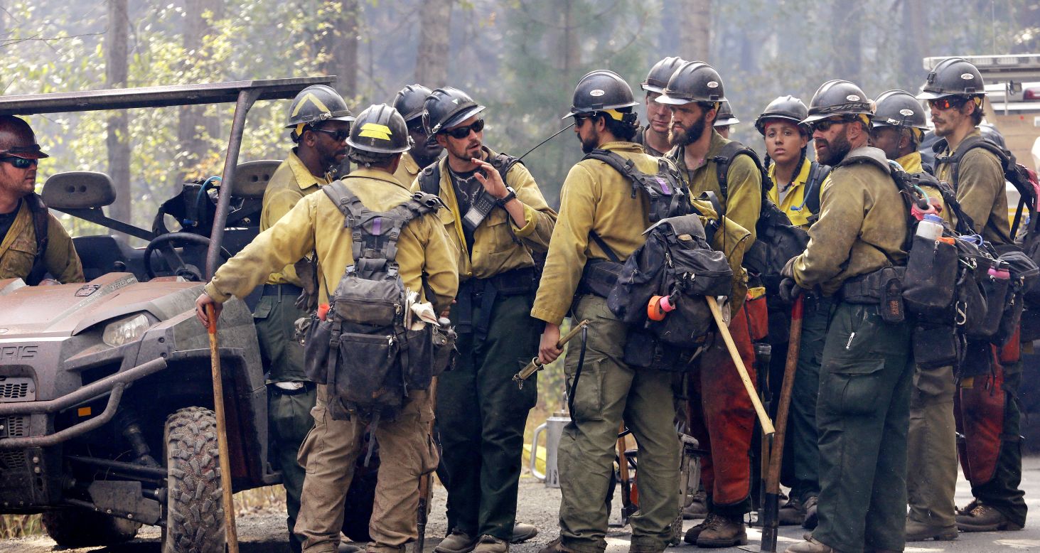 A crew leader talks to his firefighters about their plans to attack a fire burning in Twisp on August 20.