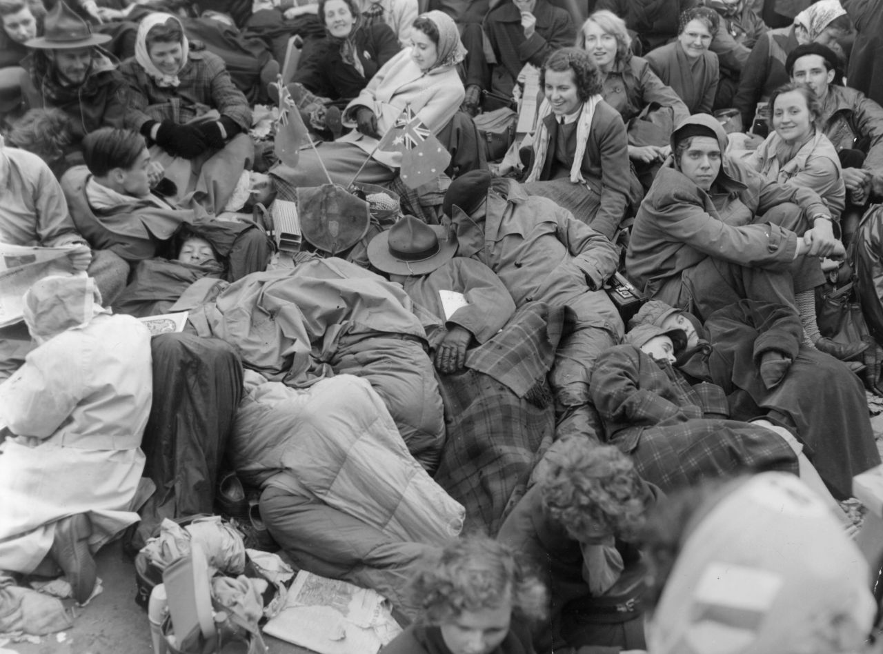 Crowds wake up to rain after spending all night sleeping in Trafalgar Square before the Queen's coronation.