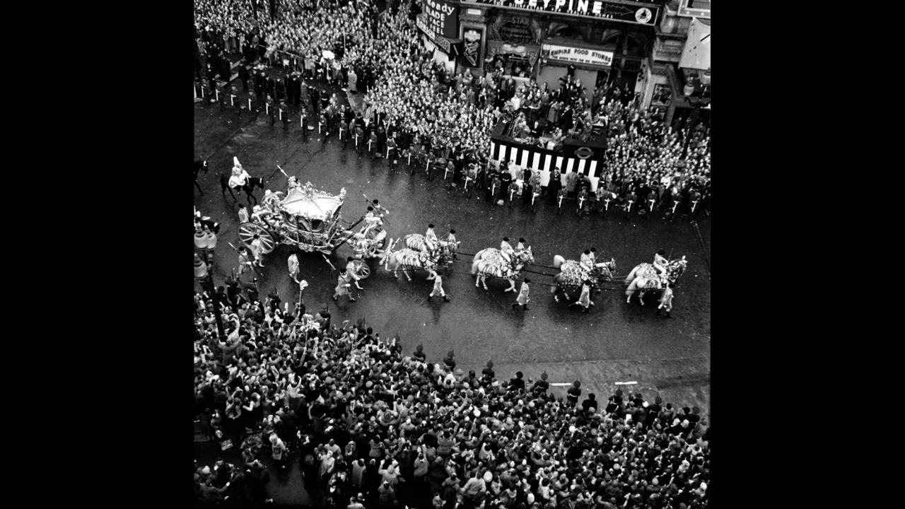 The Queen's coach passes Piccadilly Circus during the procession.