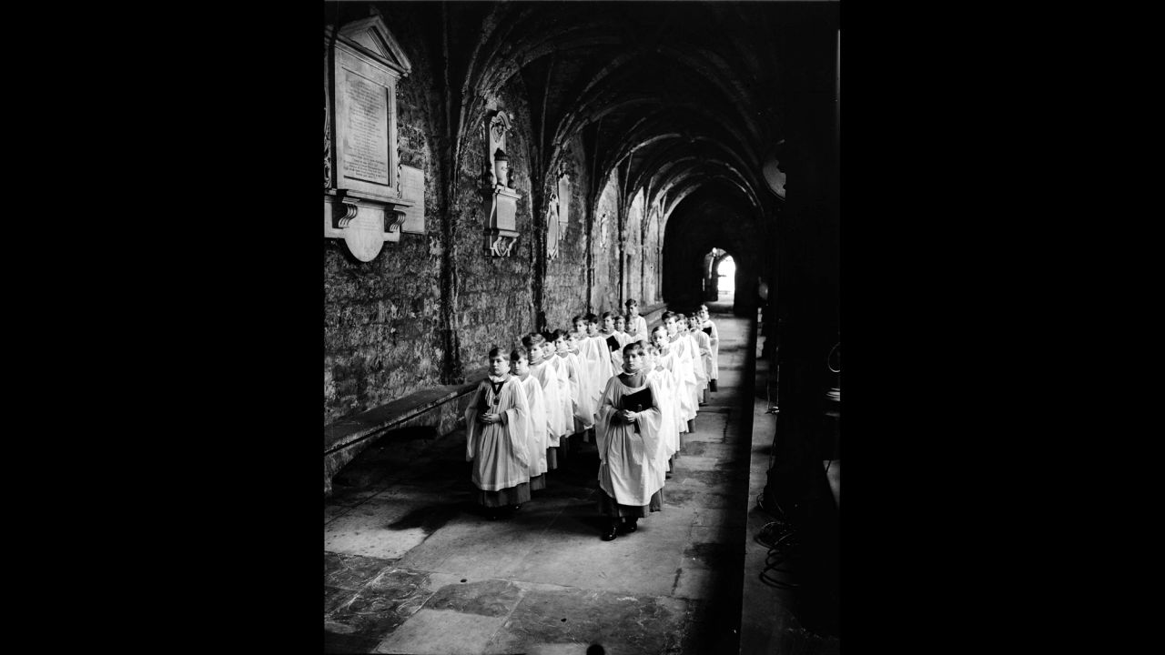 Choir boys walk through the cloisters of Westminster Abbey.