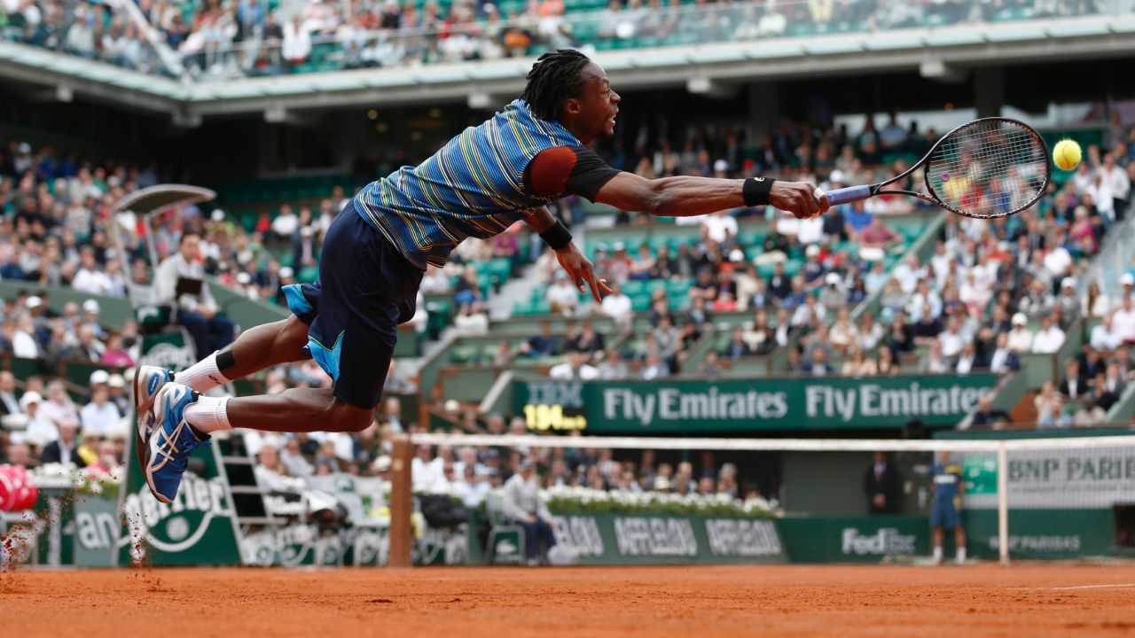 France's Gael Monfils dives in a try to return to Czech Republic's Tomas Berdych during their French Tennis Open first round match at the Roland Garros stadium in Paris, on May 27, 2013. AFP PHOTO / THOMAS COEX (Photo credit should read THOMAS COEX/AFP/Getty Images)
