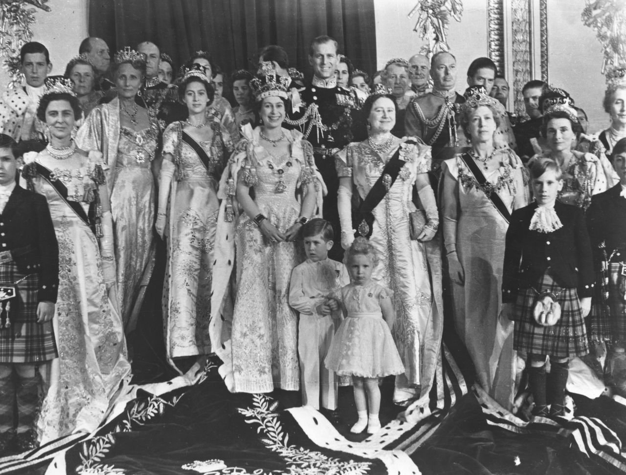 Members of the royal family pose for a photo in the throne room of Buckingham Palace.