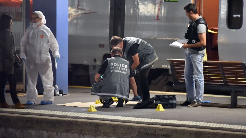 Police work on a platform next to a Thalys train of French national railway operator SNCF at the main train station in Arras, northern France, on August 21, 2015. A gunman opened fire on a train travelling from Amsterdam to Paris, injuring three people before being overpowered by passengers, French state rail company SNCF and rescue services said. Two of the victims were seriously injured and at least one suffered gunshot wounds, an SNCF spokesman said, adding that the assailant was armed with guns and knives. The motives behind the attack were not immediately known. AFP PHOTO / PHILIPPE HUGUEN        (Photo credit should read PHILIPPE HUGUEN/AFP/Getty Images)
