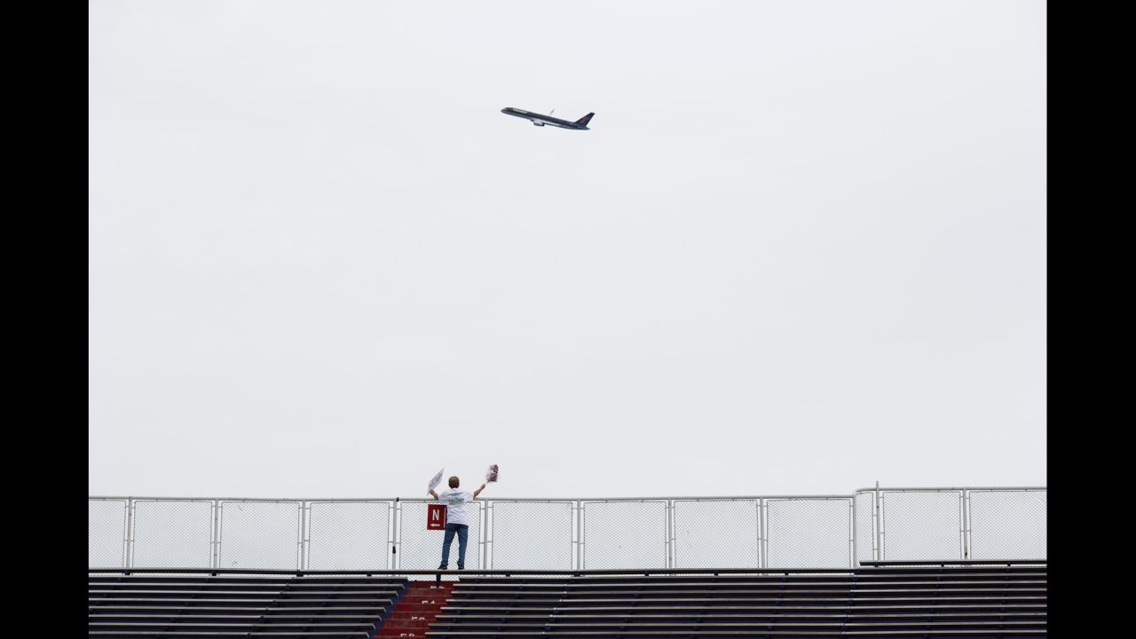 Trump's 757 plane circles the venue as he arrives. Trump flew by the stadium in his private jet shortly before 6 p.m., doing a loop around the arena before landing. The fly-by was announced over the stadium's loudspeaker to cheers.