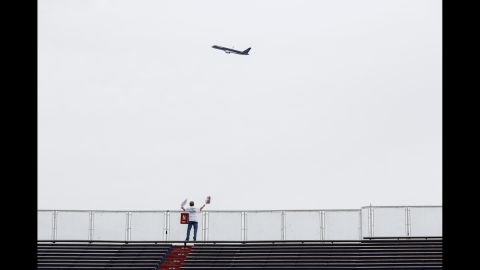 Trump's 757 plane circles the venue as he arrives. Trump flew by the stadium in his private jet shortly before 6 p.m., doing a loop around the arena before landing. The fly-by was announced over the stadium's loudspeaker to cheers.