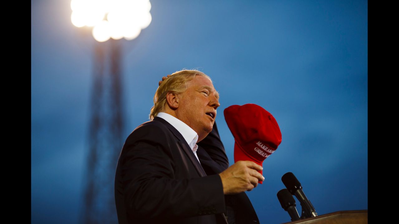 Trump, clad in a navy blue jacket and his own cherry-red "Make America Great Again" red baseball cap, won the admiration of hometown hero US Sen. Jeff Sessions. The Alabama Republican did not endorse Trump, but came onstage to endorse Trump's immigration positions while wearing his own off-white, Trump-branded hat.