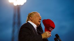 Donald Trump briefly takes off his signature hat during his rally in Mobile, AL on Friday, August 21, 2015.

Trump, clad in a navy blue jacket and his own cherry-red "Make America Great Again" red baseball cap, won the admiration of hometown hero Jeff Sessions. The Alabama Republican senator did not endorse Trump, but came on stage to endorse Trump's immigration positions while wearing his own off-white, Trump-branded hat.