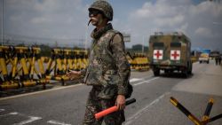 A South Korean soldier stands at a checkpoint on the Unification Bridge leading to North Korea near the border village of Yeoncheon in the Demilitarized Zone (DMZ) on August 22, 2015. South Korean troops stood at maximum alert on August 22, hours before the expiry of a North Korean ultimatum for Seoul to halt loudspeaker propaganda broadcasts across the border or face military action.       AFP PHOTO / Ed Jones        (Photo credit should read ED JONES/AFP/Getty Images)