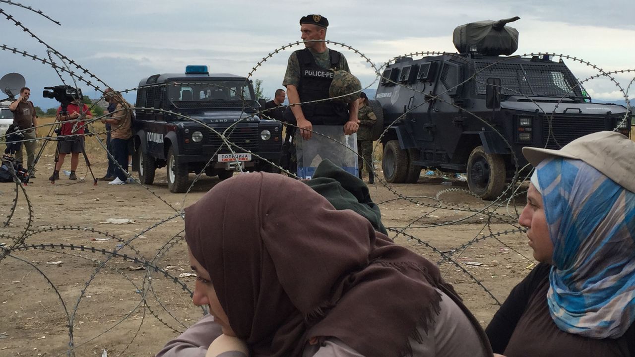 Armored vehicles and soldiers wait on the Macedonian side of the border, preventing people from rushing the border. They sporadically allow refugees to cross.