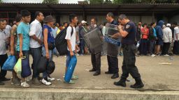 On the Macedonian side, the migrants who have been allowed to cross are put on a train at the Gvegeljia train station. 

0664- Police let them on the train few at a time.