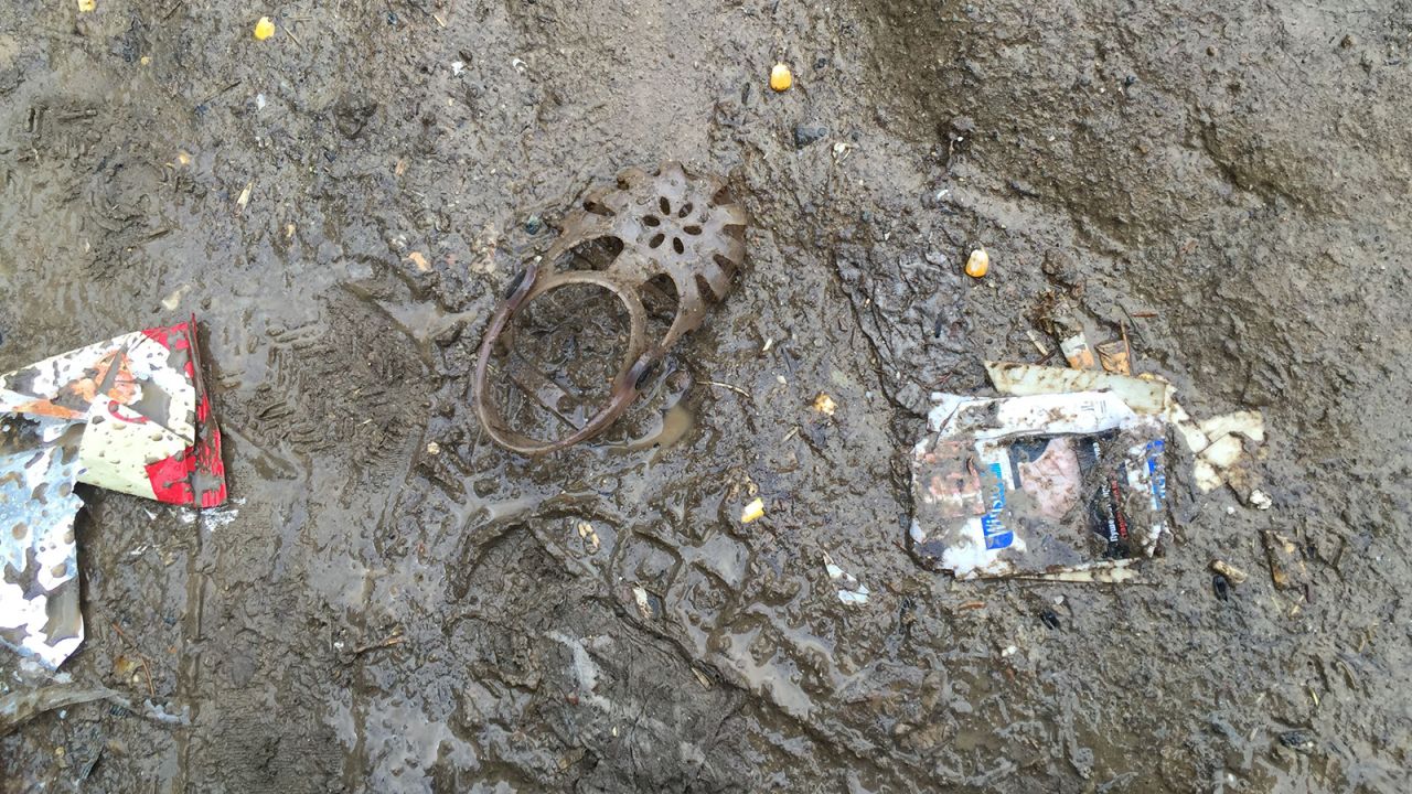 A child's shoe in the mud. Many lose their shoes in the chaos on the border.