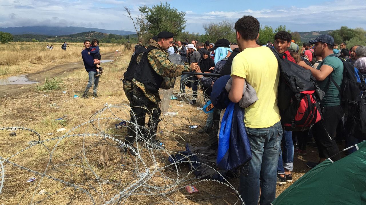 Macedonian border guards as they try to keep migrants from crossing the razor fence. 