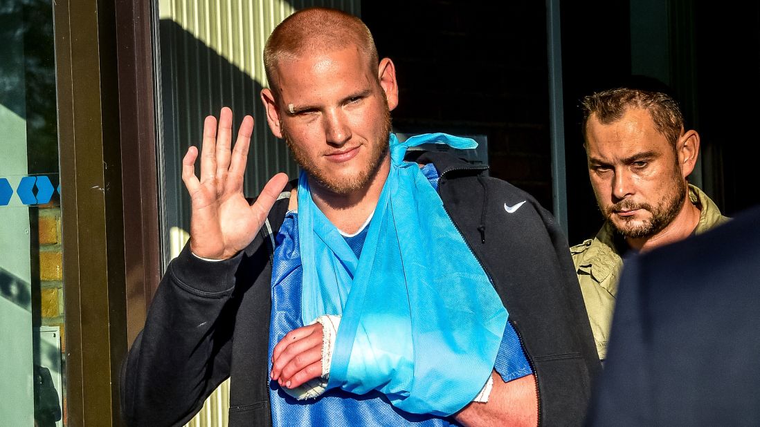 Spencer Stone, one of the passengers who overpowered the gunman who had an assault rifle on a high-speed train, gestures as he leaves the hospital of Lesquin, northern France, on Saturday, August 22. On August 21, a gunman opened fire on the train traveling from Amsterdam to Paris, injuring two people before being tackled by several passengers. Stone, an off-duty member of the U.S. Air Force, was first to the gunman, who slashed him in the neck and almost sliced off his thumb with a box utter.