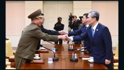 PANMUNJON, SOUTH KOREA - AUGUST 22: In this handout image provided by South Korean Unification Ministry, South Korean National Security Adviser Kim Kwan-Jin (R), South Korean Unification Minister Hong Yong-Pyo (2nd R), Kim Yang-Gon (2nd L), the top North Korean official in charge of inter-Korean affairs, and Hwang Pyong-So (L) the North Korean military's top political officer, shake hands during the inter-Korean high-level talks at the truce village of Panmunjom inside the Demilitarized Zone on August 22, 2015.  (Photo by South Korean Unification Ministry via Getty Images)
