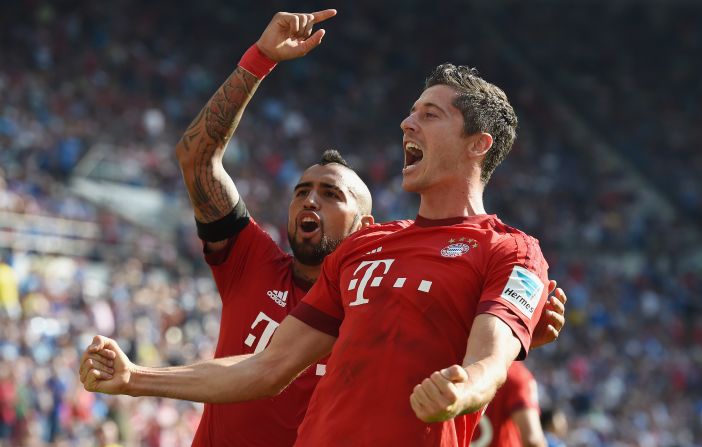 Substitute Robert Lewandowski (right) celebrates with Arturo Vidal after scoring Bayern Munich's late winner against Hoffenheim. 