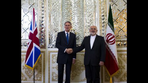 Iranian Foreign Minister Mohammad Javad Zarif (right) shakes hands with his British counterpart Philip Hammond prior to their joint press conference in Tehran on Sunday.