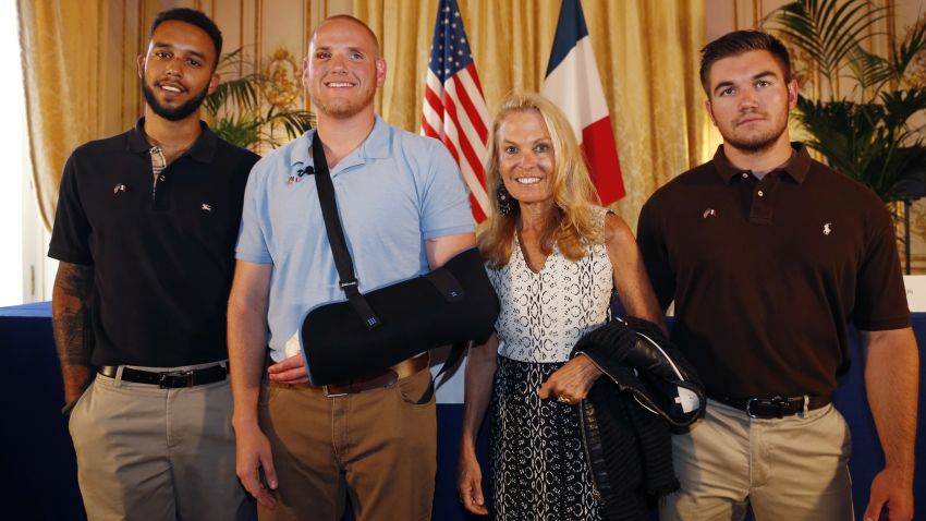 Off-duty US servicemen Anthony Sadler (L), Spencer Stone (2nd L), Alek Skarlatos (R) and US ambassador to France Jane Hartley (2nd R) pose after a press conference at the US embassy in Paris on August 23,  two days after 25-year-old Moroccan Ayoub El-Khazzani opened fire on a Thalys train travelling from Amsterdam to Paris, injuring two people before being tackled by several passengers including off-duty American servicemen.