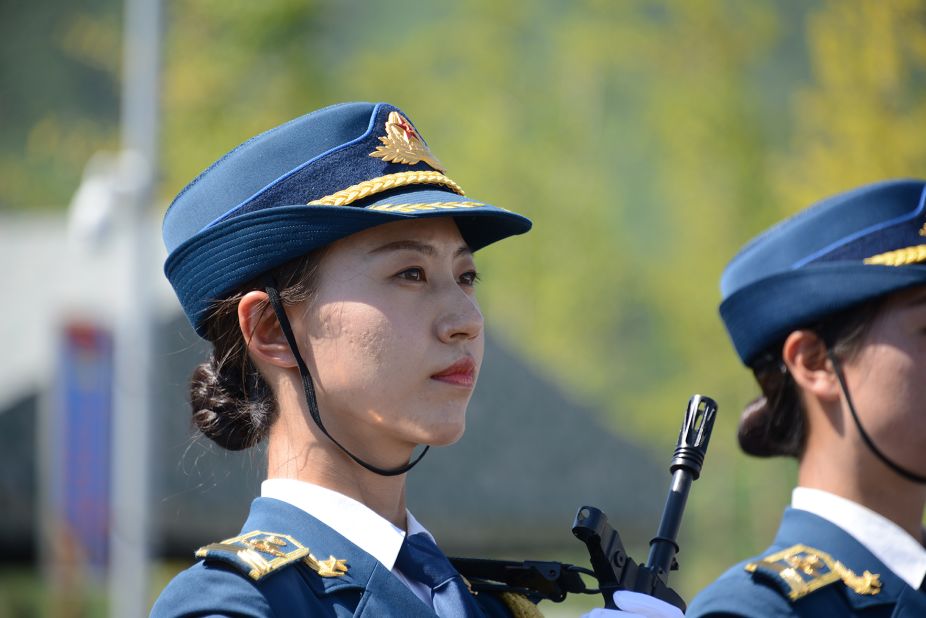 Cheng Cheng, a female squadron commander, told a group of reporters that the toughest part for female honor guards is to hold on to the heavy rifles while standing. The rifles weigh 7.17 pounds. 