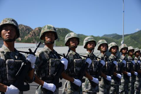 People's Liberation Army soldiers stand to attention in their combat fatigues on August 22.