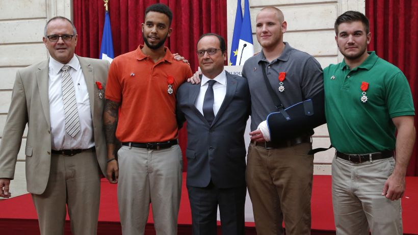 From the left, British businessman Chris Norman,  Anthony Sadler, a senior at Sacramento University in California, French President Francois Hollande, U.S. Airman Spencer Stone, and Alek Skarlatos a U.S. National Guardsman from Roseburg, Oregon pose at the Elysee Palace, Monday Aug.24, 2015 in Paris, France. Hollande  pinned the Legion of Honor medal on U.S. Airman Spencer Stone, National Guardsman Alek Skarlatos, and their years-long friend Anthony Sadler, who subdued the gunman as he moved through the train with an assault rifle strapped to his bare chest. The British businessman, Chris Norman, also jumped into the fray. (AP Photo/Michel Euler, Pool)