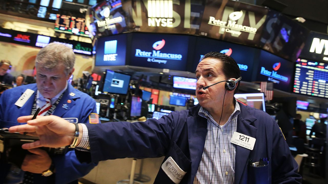 Traders work on the floor of the New York Stock Exchange on Friday, August 21, in New York City. The Dow continued to fall on August 24 as worries about China caused a global sell-off.