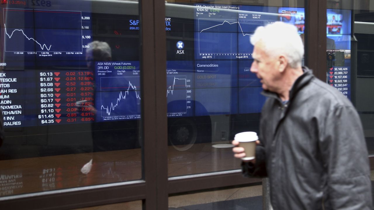 A man looks at the ASX trading board outside Exchange Square in Sydney, Australia, on August 24.