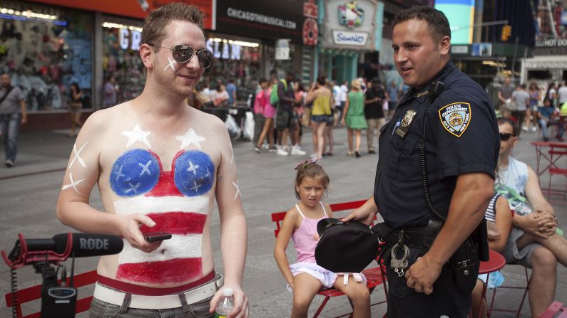 A young man parodies the topless women in Times Square on August 19.