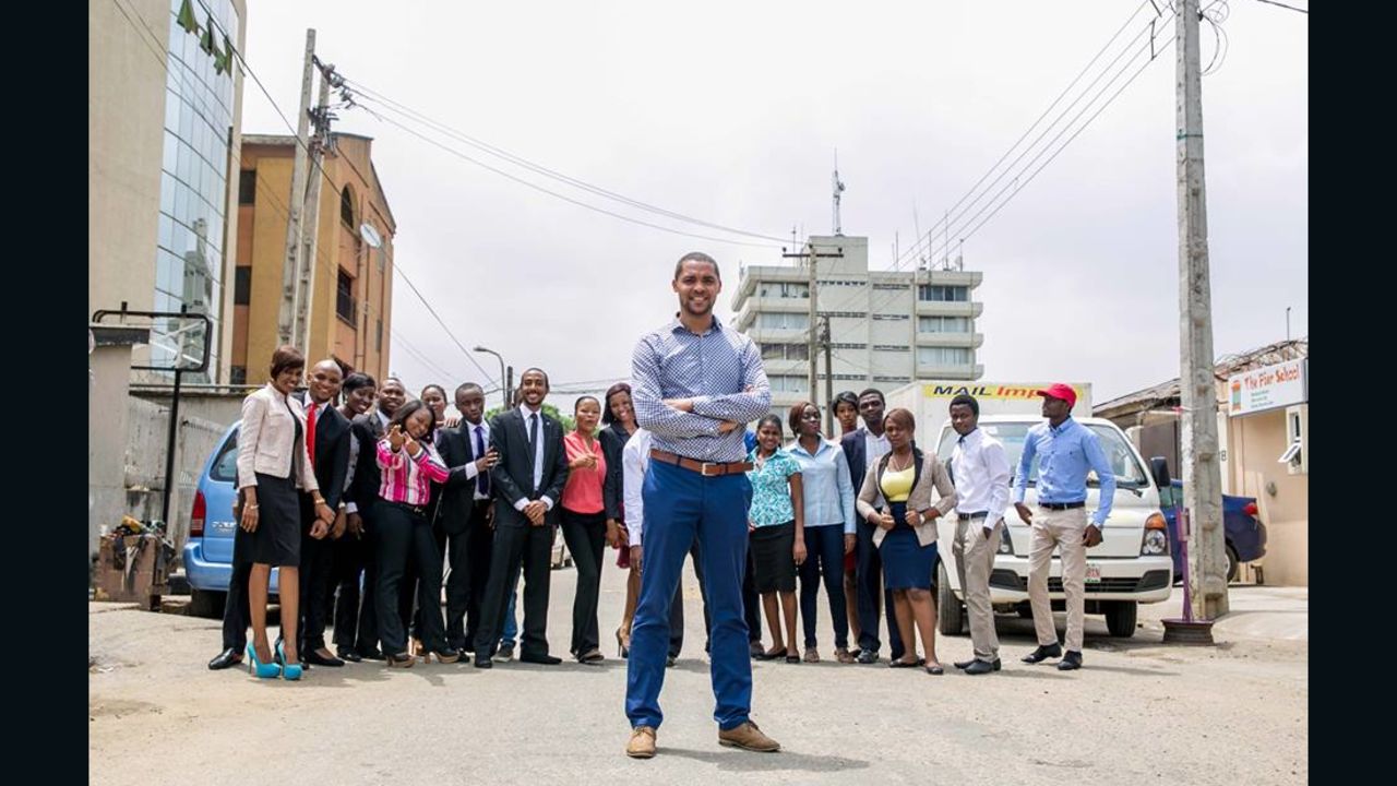 Mark Essien with his growing Hotels.ng team on Olonade street in Sabo, Yaba, Lagos.