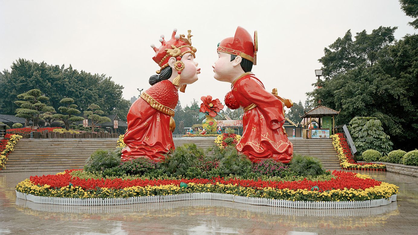 This life-sized statue of a popular figurine portrays a happy Chinese couple dressed in traditional wedding garb. In China, the color red is a symbol of love, prosperity, and happiness. 