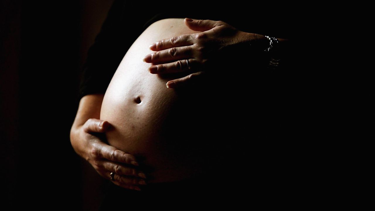 SYDNEY, NSW - JUNE 07:  A pregnant woman holds her stomach June 7, 2006 in Sydney, Australia. Australia is currently enjoying a baby boom, with the Australian Bureau of Statistics registering a 2.4% increase in births from 2004 to 2005, which represents the highest number of births since 1992. The Australian Federal Government has been encouraging people to have more babies, with financial incentives and the slogan by treasurer Peter Costello to "have one for mum, one for dad, and one for the country". The Federal Government has identified falling fertility rates and the ageing population as long-term problems for Australia's growth and prosperity.  (Photo by Ian Waldie/Getty Images)