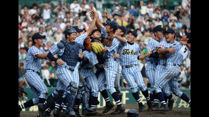 High school players from Tokaidai Sagami celebrate after winning the national championship Thursday, August 20, in Nishinomiya, Japan.